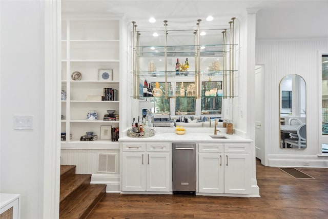 bar with white cabinets, dark hardwood / wood-style floors, and sink