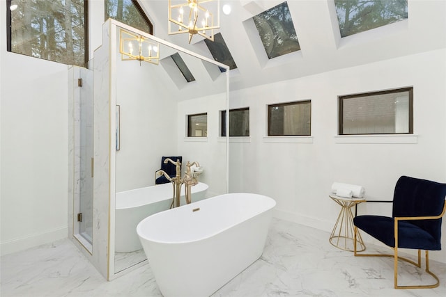 bathroom with shower with separate bathtub, an inviting chandelier, and vaulted ceiling with skylight