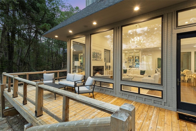 deck at dusk with an outdoor hangout area