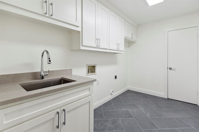 laundry room featuring sink, cabinets, washer hookup, hookup for an electric dryer, and dark tile patterned floors