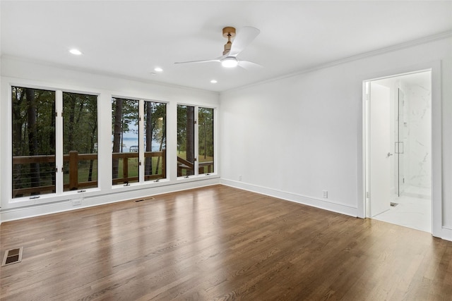 spare room with ceiling fan, crown molding, and wood-type flooring