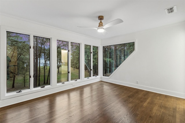 unfurnished sunroom with ceiling fan