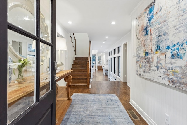 hallway featuring crown molding and dark wood-type flooring