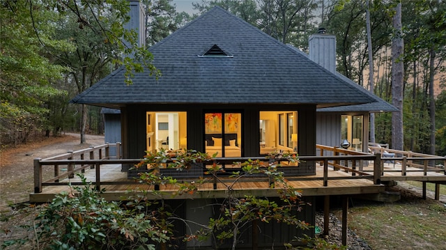 rear view of house featuring a wooden deck