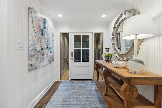 doorway featuring dark hardwood / wood-style flooring and ornamental molding