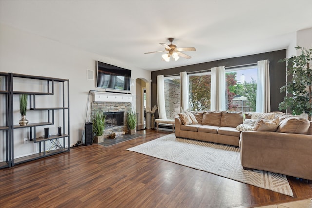 living room with ceiling fan, a fireplace, and hardwood / wood-style flooring