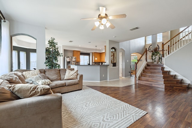 living room with ceiling fan and wood-type flooring