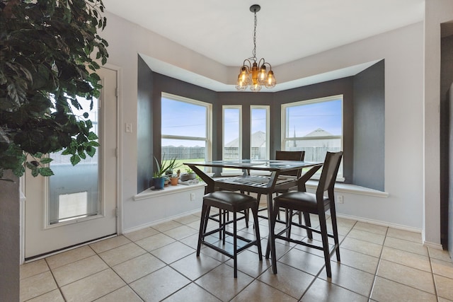 tiled dining area with an inviting chandelier