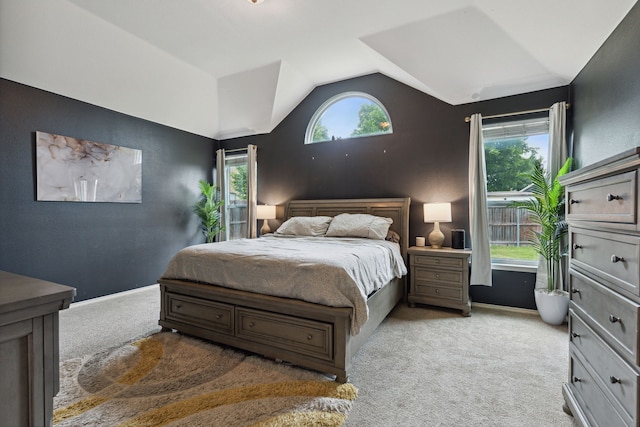 bedroom with light colored carpet and vaulted ceiling