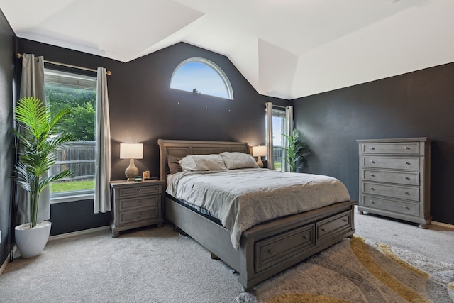 carpeted bedroom with lofted ceiling