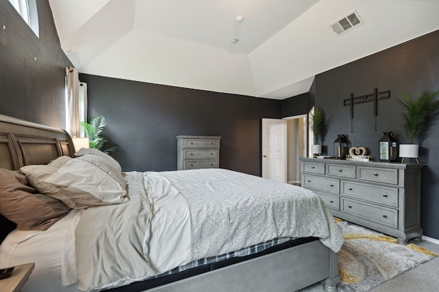 bedroom with carpet flooring and a raised ceiling