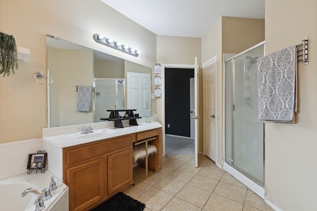 bathroom featuring tile patterned flooring, shower with separate bathtub, and vanity