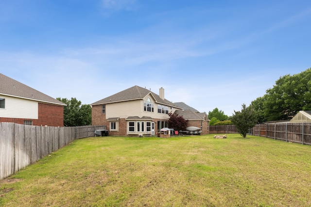 rear view of property with a yard