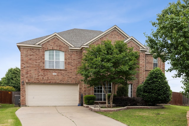 view of front of house featuring a front lawn and a garage