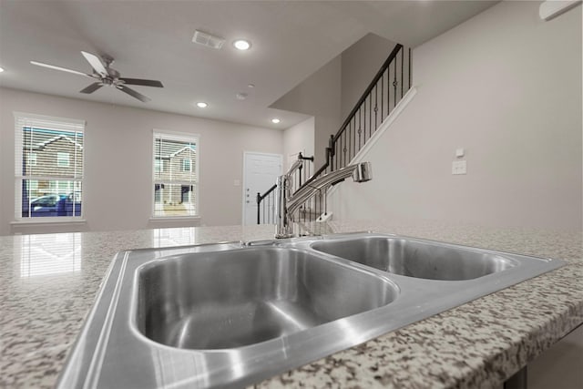 details with light stone countertops and sink