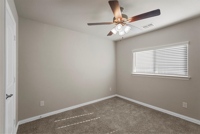 carpeted spare room featuring ceiling fan