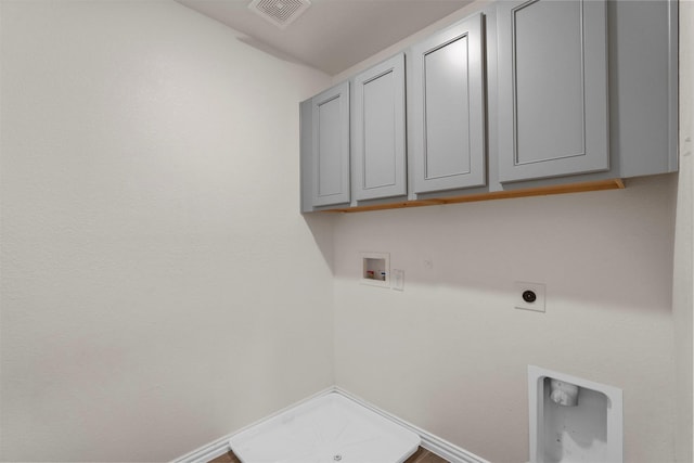 washroom featuring hookup for an electric dryer, washer hookup, and cabinets