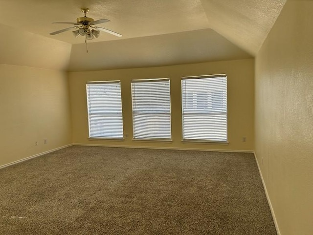 spare room featuring carpet flooring, ceiling fan, and lofted ceiling