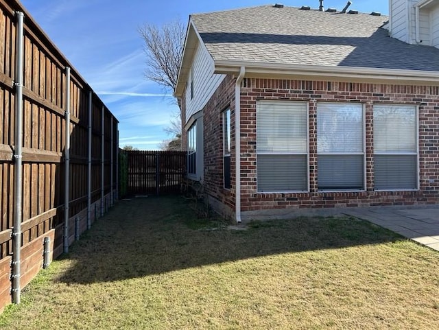 view of side of property with a yard