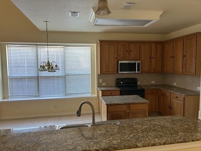 kitchen with pendant lighting, sink, black electric range, tasteful backsplash, and a chandelier