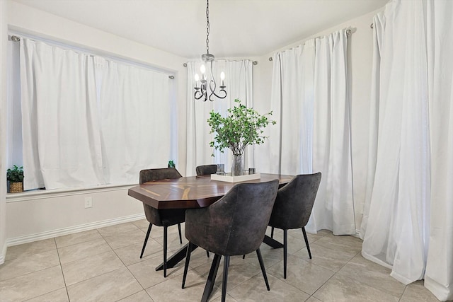 dining room with light tile patterned floors and a chandelier