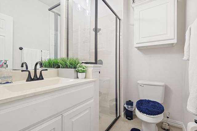 bathroom featuring toilet, a shower with door, and vanity