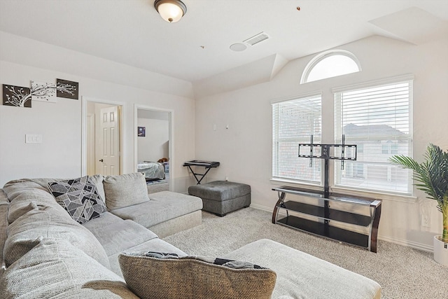 living room featuring light carpet and vaulted ceiling