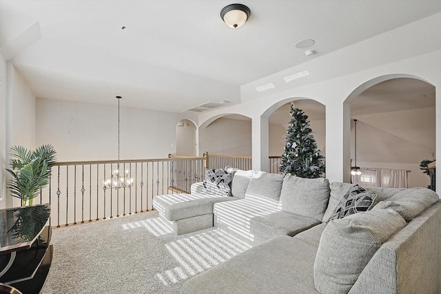 living room featuring an inviting chandelier and carpet flooring