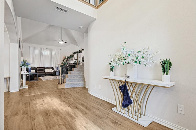 foyer featuring vaulted ceiling, ceiling fan, and hardwood / wood-style flooring