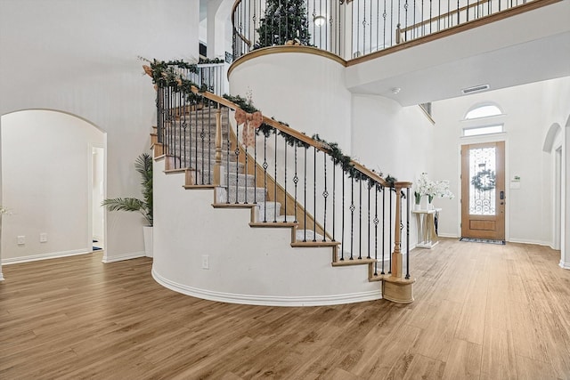 foyer with a high ceiling and hardwood / wood-style floors