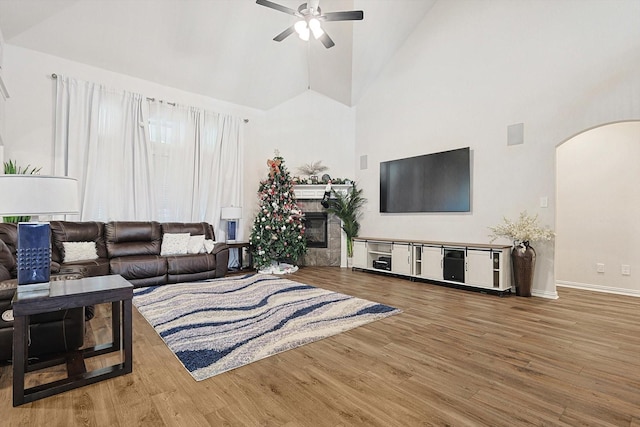 living room with high vaulted ceiling, hardwood / wood-style flooring, and ceiling fan