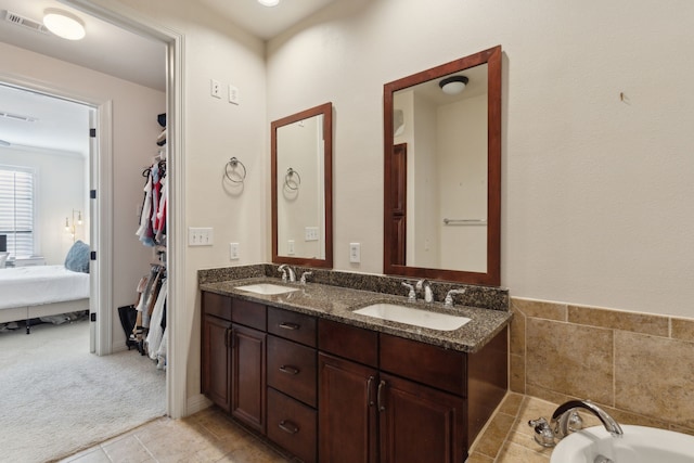 full bath with a sink, visible vents, ensuite bath, and double vanity