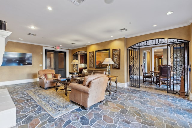 living room featuring visible vents, stone flooring, and ornamental molding