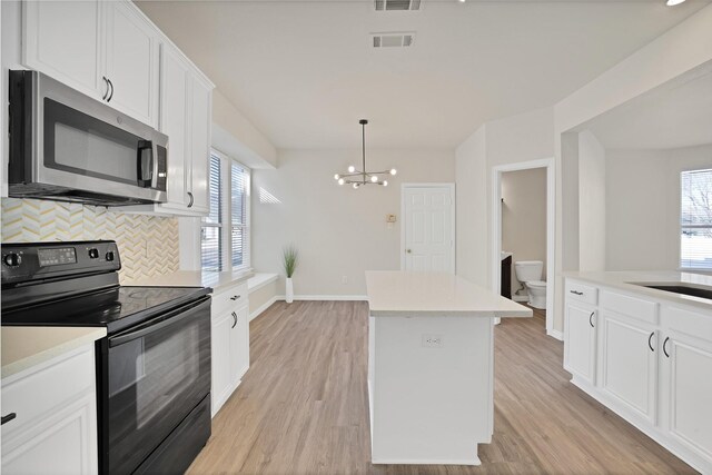 unfurnished dining area with hardwood / wood-style floors and an inviting chandelier