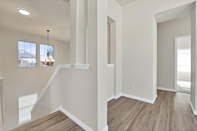 interior space with a closet, ceiling fan, built in desk, and light hardwood / wood-style floors