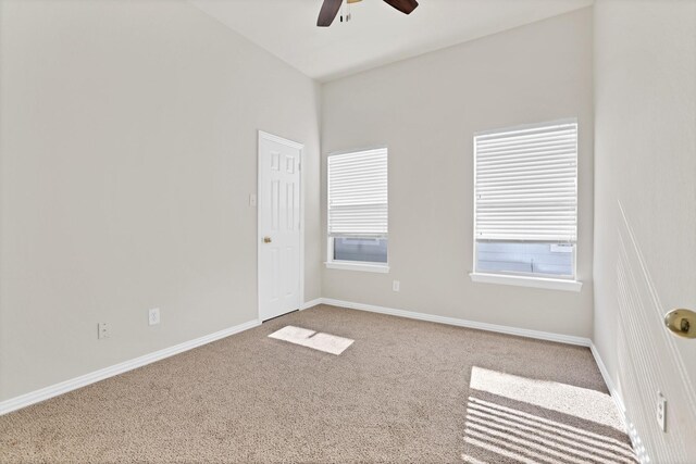 unfurnished room featuring carpet flooring and lofted ceiling