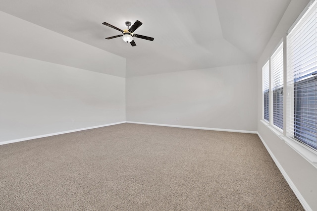 spare room featuring ceiling fan, carpet flooring, and vaulted ceiling