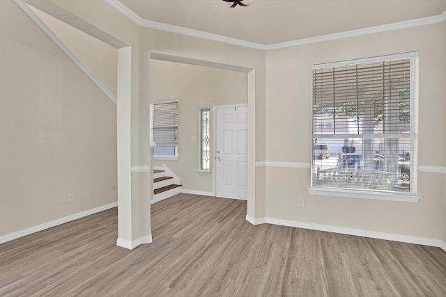 foyer featuring crown molding and light hardwood / wood-style flooring