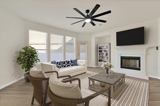 living room with ceiling fan and light hardwood / wood-style flooring