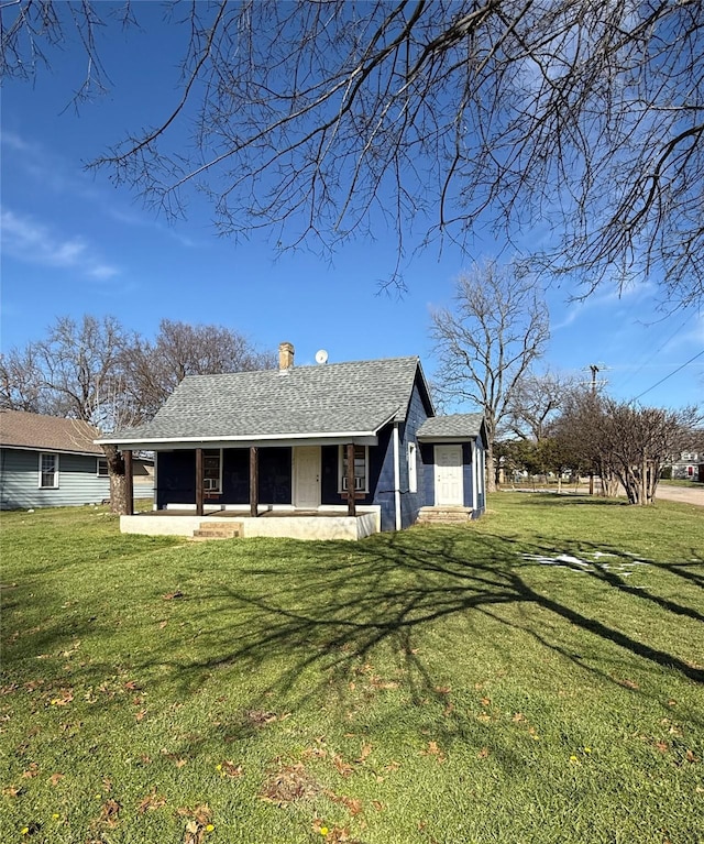 rear view of property featuring a patio and a yard