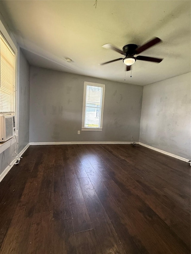 spare room with ceiling fan and dark wood-type flooring