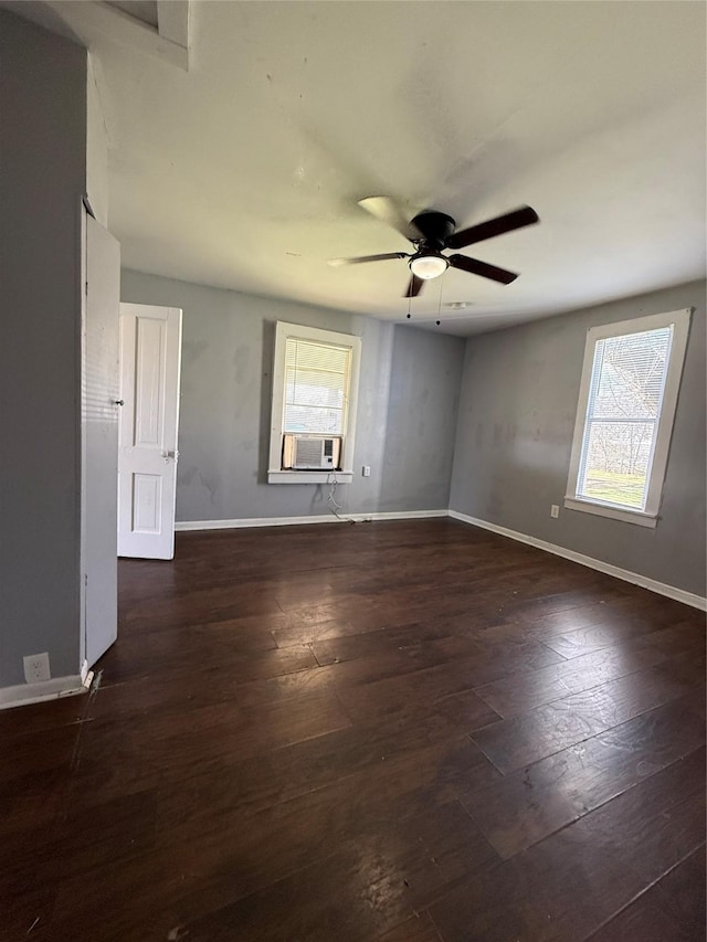 empty room with cooling unit, ceiling fan, and dark wood-type flooring