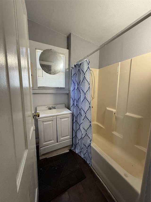 bathroom featuring hardwood / wood-style flooring, shower / bath combo, and vanity