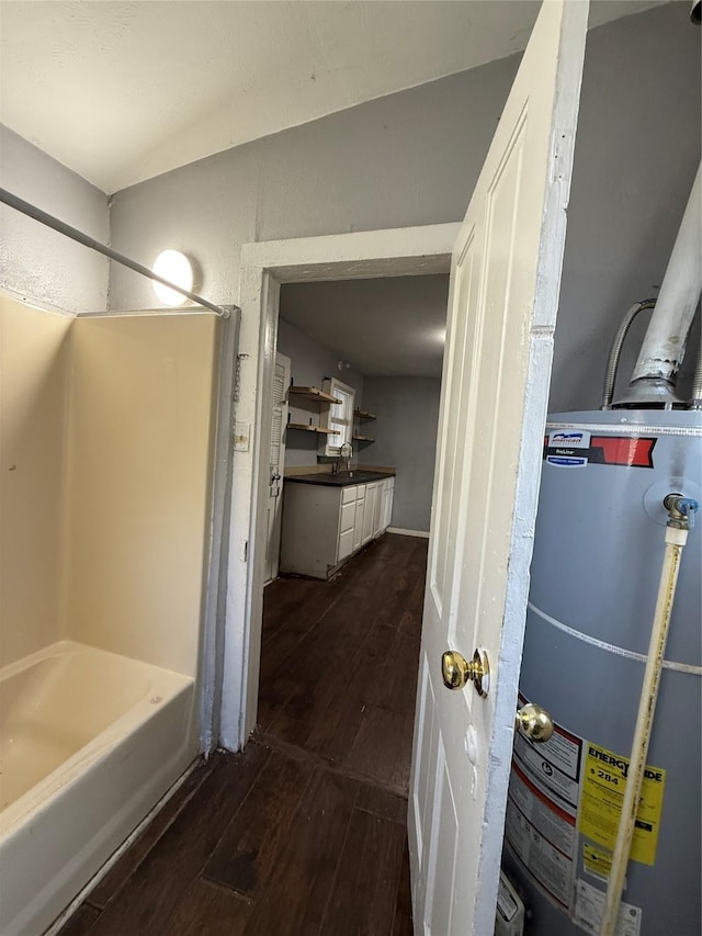 interior space featuring gas water heater, sink, and hardwood / wood-style flooring