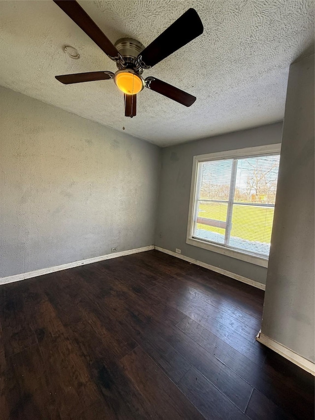 spare room featuring ceiling fan, a textured ceiling, and dark hardwood / wood-style floors