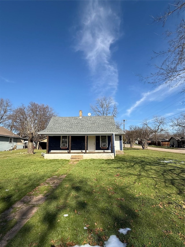 back of house with a lawn