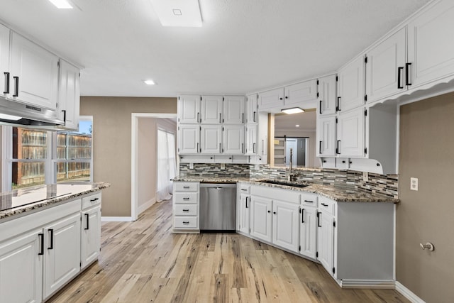 kitchen featuring dishwasher, white cabinetry, and sink