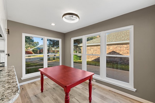 dining space featuring plenty of natural light and light hardwood / wood-style flooring