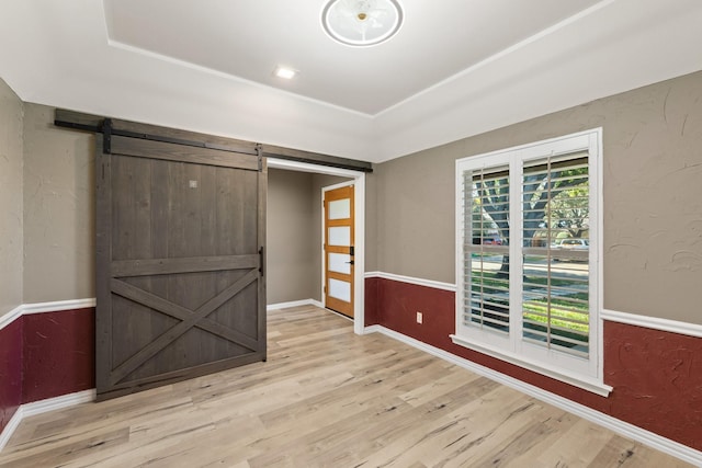 interior space featuring a barn door and light wood-type flooring