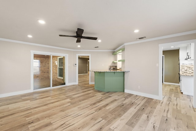 unfurnished living room with crown molding, ceiling fan, and light hardwood / wood-style floors